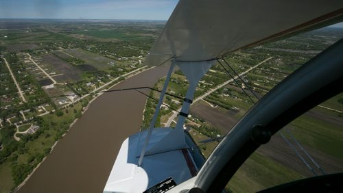 View from the canopy over the Red River in the Pitts S2B aerobatic biplane over St. Andrews. The black wire attached to the wing struts is a sighting device, which helps the pilot align the plane during intense aerobatic manoeuvres. Harv's Air Pilot Training offers rides in the Pitts S2B aerobatic biplane for $250 a demonstration ride. The trip can include loops, rolls, hammerheads, barrel rolls and vertical rolls among other aerobatic maneuvers.  June 04, 2015 - MELISSA TAIT / WINNIPEG FREE PRESS