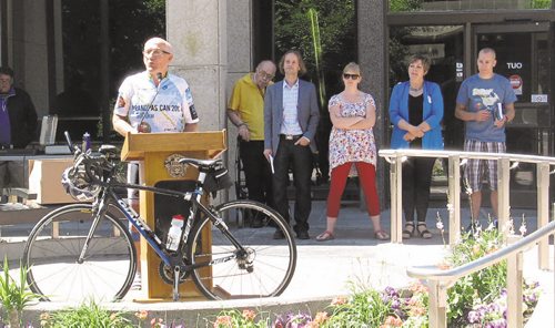 Canstar Community News June 18, 2015 - Arvin Loewen speaks before setting off on Winnipeg's Longest Bike Commute. The 29 hour cycle within the Perimeter is organized to encourage cycling, show support for the City of Winnipeg's effort to improve active transportation and to promote Arvin's upcoming 9000km bike ride. In the background, left to right, unidentified man, event MC Paul Boge, Bike Week Winnipeg coordinator Andraea Sartison, city councillor Janice Lukes, and Paul Loewen, ride support crew. (SHELDON BIRNIE/CANSTAR COMMUNITY NEWS/THE HERALD).