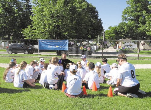 Canstar Community News June 18, 2015 - Oliver Fiest (centre), a visiting Auf Ballhohe soccer coach from Munich, Germany, instructs a group of Grade 4 German Bilingual program students at Princess Margaret School during a week-long German soccer camp. (SHELDON BIRNIE/CANSTAR COMMUNITY NEWS/THE HERALD)