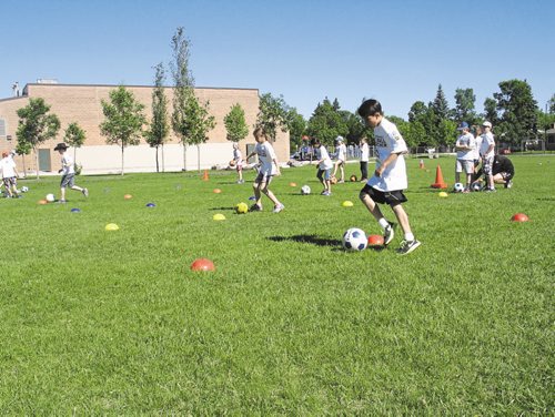 Canstar Community News June 18, 2015 - A group of kids run through a set of drills as part of the River East-Transcona School Division's German Bilingual Program soccer camp. (SHELDON BIRNIE/CANSTAR COMMUNITY NEWS/THE HERALD)