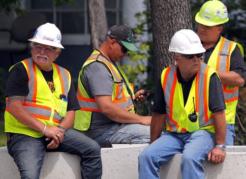 Major gas leak when a cement cutter hit a 12in gas line just south of Eugenie and Des Meurons. Here the construction crew involved sit and wait. The fella second from the left is the one that was operating the saw that cut the pipe. BORIS MINKEVICH/WINNIPEG FREE PRESS June 23, 2015