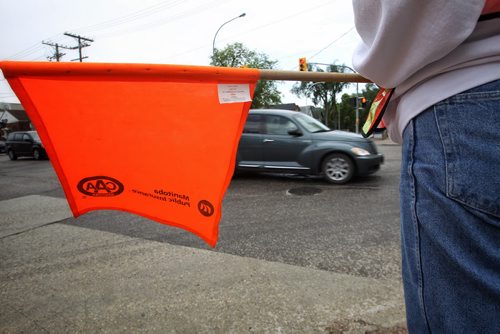 A crossing guard started a Facebook group recently to list license plate numbers of people who drive dangerously through the intersection she works at. 150623 June 23, 2015 MIKE DEAL / WINNIPEG FREE PRESS