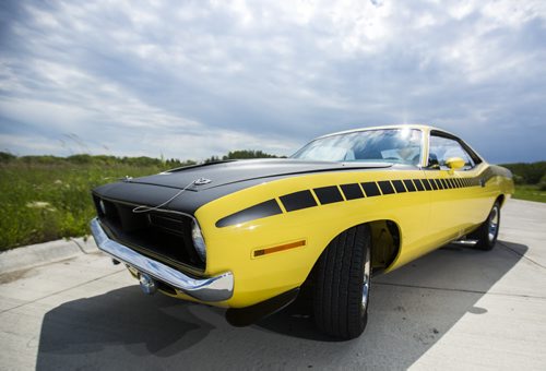 Rhonda Reyher shows off her 1970 AAR 'Cuda, which she believes to be one of the only ones in Manitoba, in Winnipeg on Tuesday, June 23, 2015. Mikaela MacKenzie / Winnipeg Free Press