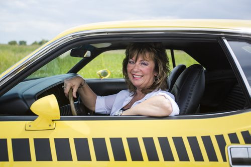 Rhonda Reyher shows off her 1970 AAR 'Cuda, which she believes to be one of the only ones in Manitoba, in Winnipeg on Tuesday, June 23, 2015. Mikaela MacKenzie / Winnipeg Free Press