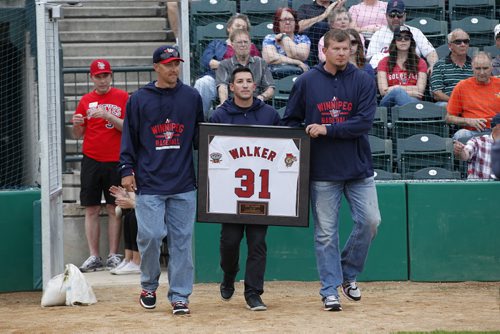 June 23, 2015 - 150623  - Former Goldeyes carry out Ace Walker's jersey which was presented to him at a celebration to retire his jersey prior to the Goldeye's game against the Gary Southshore Railcats in Winnipeg Tuesday, June 23, 2015. John Woods / Winnipeg Free Press