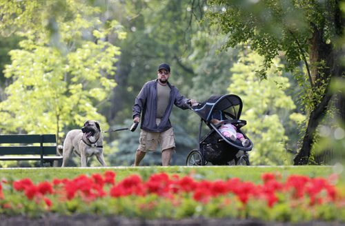 Douglas Courtemanche with his daughter Aria and friend Harvey enjoy the beautiful Wednesday morning in Kildonan Park after the thunder showers earlier. Wayne Glowacki / Winnipeg Free Press June 24  2015