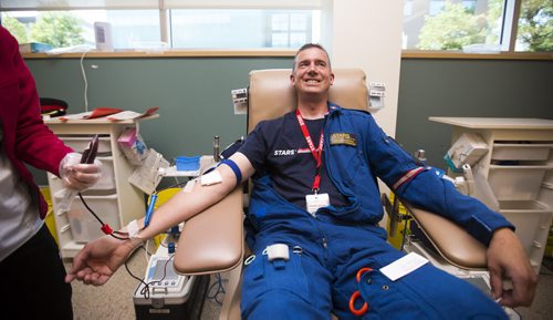 STARS flight paramedic Brent Bekiaris gives blood as part of the Sirens for Life initiative at the Canadian Blood Services in Winnipeg on Thursday, June 25, 2015. Mikaela MacKenzie / Winnipeg Free Press