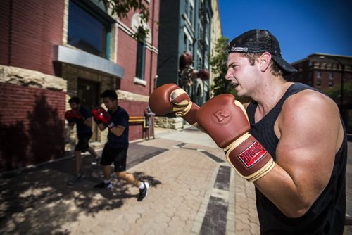 Aaron Black, instructor at Pan Am Boxing, teaches a corporate class in front of the building in downtown Winnipeg on Thursday, June 25, 2015. Mikaela MacKenzie / Winnipeg Free Press