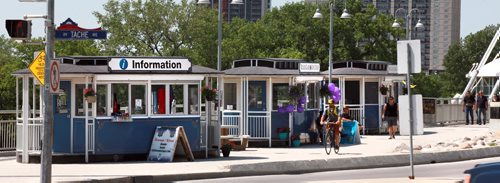 Three seasonal kiosks designed to look like horse-drawn trams from the early 1900s open each summer on the Plaza area at the east end of the Esplanade Riel bridge. Enterprises Riel, the economic development agency for the local French community, sets the kiosks up each year for the summer. Its tourism arm operates a tourist information centre out of one, and the the other two are food kiosks. One sells house-made frozen treats and the other features African cuisine. See Murray McNeil's story. June 26, 2015 - (Phil Hossack / Winnipeg Free Press)