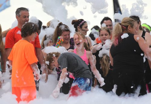 Teams of runners are covered in foam at the start gate of Adrenaline Adventures, Foam Fest, a funny 5k obstacle course that takes participants through mud, rope climbs and bouncers Saturday.  Standup photo   June 27,, 2015 Ruth Bonneville / Winnipeg Free Press