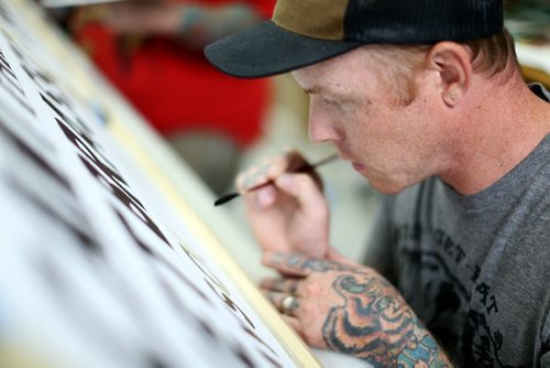 Lucas Ford from Red Deer, Alberta came to participate. Mike Meyer was brought in to instruct a sign painting workshop at Signmeister, Saturday, June 27, 2015. The art of hand sign painting has been making a resurgence after nearly becoming obsolete due to computers and vinyl. (TREVOR HAGAN/WINNIPEG FREE PRESS)