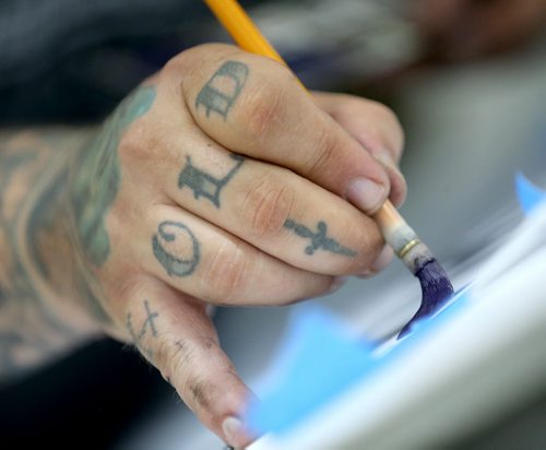 Mike Meyer was brought in to instruct a sign painting workshop at Signmeister, Saturday, June 27, 2015. The art of hand sign painting has been making a resurgence after nearly becoming obsolete due to computers and vinyl. (TREVOR HAGAN/WINNIPEG FREE PRESS)