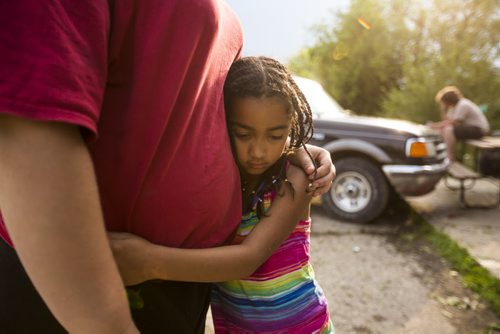 Kimisha Scott, 6, hugs her babysitter, Paige McDonald, after a severe storm in Roseisle, Manitoba damaged houses, cars, and crops on Saturday, June 27, 2015.  Mikaela MacKenzie / Winnipeg Free Press