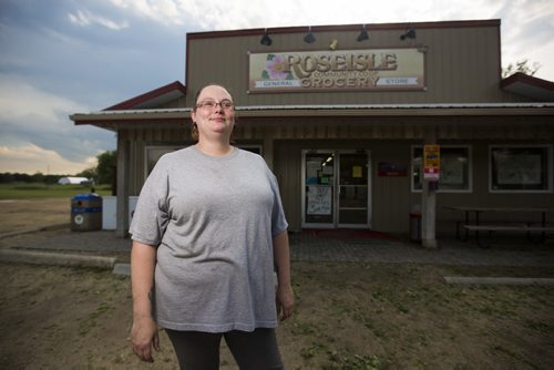 Reena Spearman stands in front of the general store where she works after a severe storm in Roseisle, Manitoba damaged houses, cars, and crops on Saturday, June 27, 2015.  The store became a gathering place for residents of the town, and they hooked up multiple generators to keep the freezers going when the power went out. Mikaela MacKenzie / Winnipeg Free Press