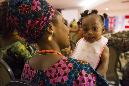 Omolulu Ogunibode dances along to the music in a family friend's arms at a multicultural celebration put on by the Nigeria Canada Congress of Manitoba on Saturday, June 27, 2015.   Mikaela MacKenzie / Winnipeg Free Press