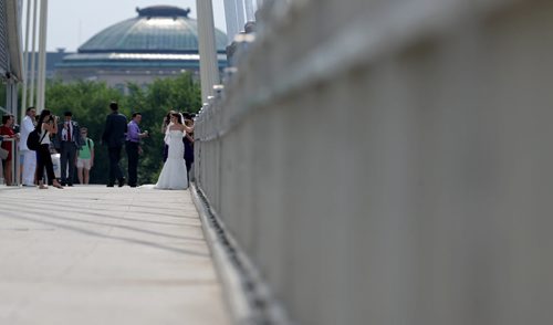 Ilana and Ilya Noureev pose for wedding photos on the Esplanade Riel, Sunday, June 28, 2015. (TREVOR HAGAN/WINNIPEG FREE PRESS)