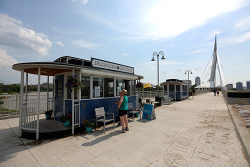 Teresa Bowerman and Val Gompf buy cool treats from Chocolatier Constance Popp. On the east side of the Esplanade Riel, three seasonal kiosks designed to look like horse-draw trams. The tourist arm of Enterprises Riel operates them, Sunday, June 28, 2015. (TREVOR HAGAN/WINNIPEG FREE PRESS) for murray mcneill