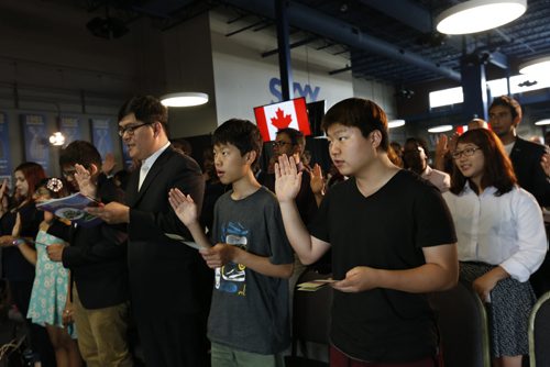 From right, brothers James and Paul Park and their uncle Greg Lee all originally from South Korea were among the 100 people giving the Oath of Citizenship at the Citizenship Ceremony in the Pinnacle Club at Investors Group Field Monday. The new Canadians were treated treated to tickets for the Winnipeg Blue Bombers Home Opener on July 2nd  and will  be honoured at the special half-time presentation with the citizens at centre field. ¤  see release .Wayne Glowacki / Winnipeg Free Press June 29  2015