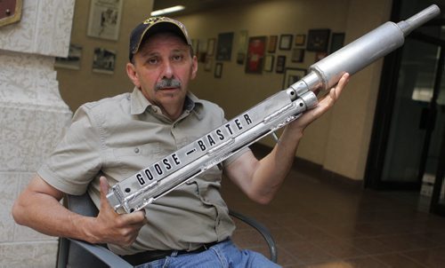 Terry Leochko has invented a gun which shoots balls of light across the water to scare away geese. BORIS MINKEVICH/WINNIPEG FREE PRESS June 29, 2015
