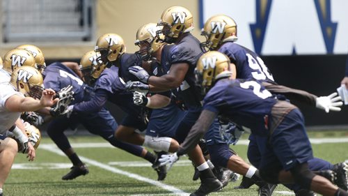 Bryant Turner Jr. #92 DT (in the centre of picture, his helmet shows #92 and is nearest to the top of the picture) at the   Winnipeg Blue Bomber practice at the Investors Group Field Monday. Tim Campbell / Scott Billeck .Wayne Glowacki / Winnipeg Free Press June 29  2015