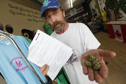 June 29, 2015 - 150629  -  Glenn Price shows his personal medical cannabis and his Manitoba business licence which shows he was up front on his business application in Winnipeg Monday, June 29, 2015. John Woods / Winnipeg Free Press