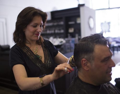 Boris Minkevich, photojournalist at the Winnipeg Free Press, gets his  hair cut to make a wig for a cancer patient at Berns & Black salon on Monday, June 29, 2015.   Mikaela MacKenzie / Winnipeg Free Press