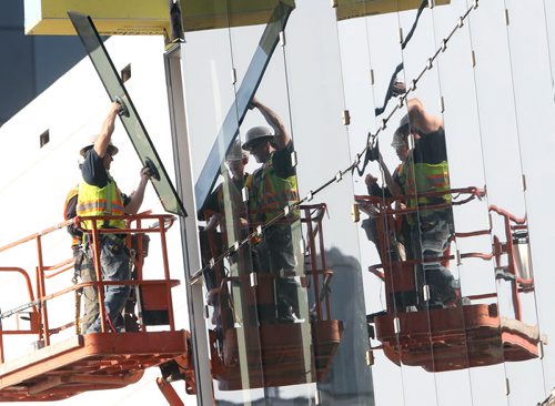 Finishing Touches- Workers install glass at the RBC Convention Centre expansion in downtown Winnipeg Tuesday- The 180 Million dollar 304,000 sq ft expansion will almost double the size of the building- Standup Photo- June 30, 2015   (JOE BRYKSA / WINNIPEG FREE PRESS)