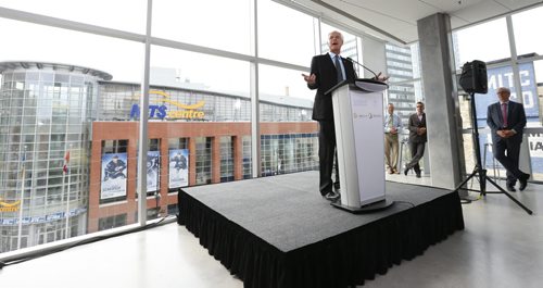 Eric Wiens, VP Regional Lead Stantec at the podium for the official grand opening of the 311 Portage Avenue at Centrepoint. This event was in the Stantec lunch room over looking the MTS Centre. Geoff Kirbyson story.  Wayne Glowacki / Winnipeg Free Press June 30  2015