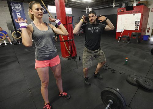 June 30, 2015 - 150630 - CrossFit coach Cole Nedohin demonstrates technique to crossfit athlete Kirsten Grom at CrossFit 204 Tuesday, June 30, 2015.  John Woods / Winnipeg Free Press