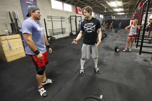 June 30, 2015 - 150630 - Mike Warkentin, CrossFit coach and co-owner of CrossFit 204, talks to an athletes as they lift weights at the gym Tuesday, June 30, 2015.  John Woods / Winnipeg Free Press