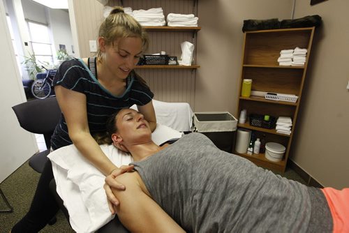 June 30, 2015 - 150630 - Natalie Marion, owner of Rise Up Physiotherapy stretches the neck muscles of Kirsten Grom at CrossFit 204 Tuesday, June 30, 2015.  John Woods / Winnipeg Free Press