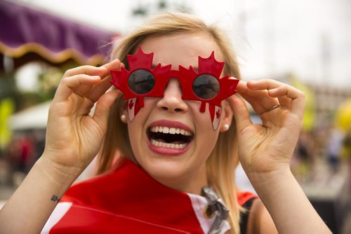 Cerah Dube celebrates Canada Day at the annual Osborne Street Festival on Wednesday, July 1, 2015. Mikaela MacKenzie / Winnipeg Free Press