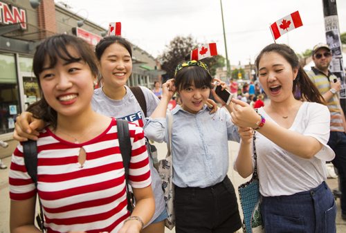 A group of Korean girls studying at the University of Manitoba celebrate Canada Day at the annual Osborne Street Festival on Wednesday, July 1, 2015. Mikaela MacKenzie / Winnipeg Free Press