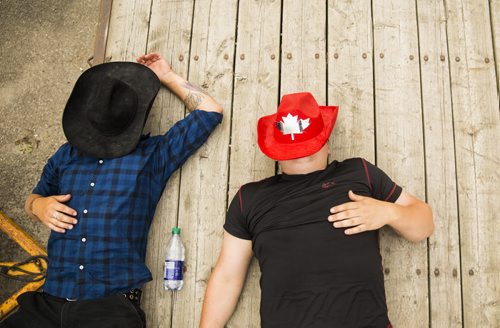 Ben Dutchuk (left) and Matt Starr relax at the annual Osborne Street Festival on Wednesday, July 1, 2015. Mikaela MacKenzie / Winnipeg Free Press