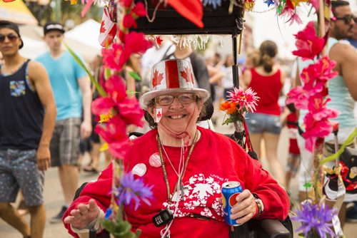 Olive Varemko celebrates Canada Day in her lavishly decorated motorized wheelchair at the annual Osborne Street Festival on Wednesday, July 1, 2015. Mikaela MacKenzie / Winnipeg Free Press