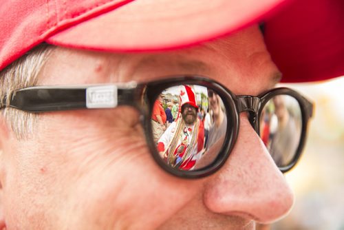 Mike Witty is reflected in his friend, Mark Joss', glasses as Winnipeggers celebrate Canada Day at the annual Osborne Street Festival on Wednesday, July 1, 2015. Mikaela MacKenzie / Winnipeg Free Press