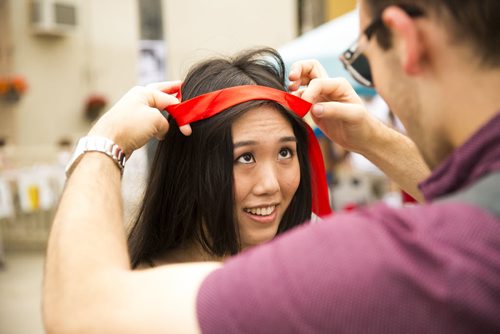 Frank Moritz puts his ver Canadian tie on his wife, Mia Ji's, head as a bandana at the annual Osborne Street Festival on Wednesday, July 1, 2015. Ji is from China, while Moritz is from Germany - they met while at the U of M and got married less than a month ago. Mikaela MacKenzie / Winnipeg Free Press