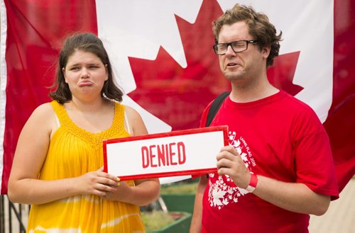 Laura Leather (left) and Matt Glays find out that they would not have made it into Canada with the strict immigration laws after taking a quiz at the annual Osborne Street Festival on Wednesday, July 1, 2015. Mikaela MacKenzie / Winnipeg Free Press