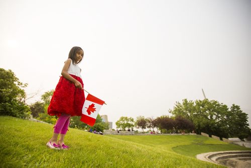 Yzabelle Juayang, 7, celebrates Canada Day at the Forks on Wednesday, July 1, 2015. Mikaela MacKenzie / Winnipeg Free Press