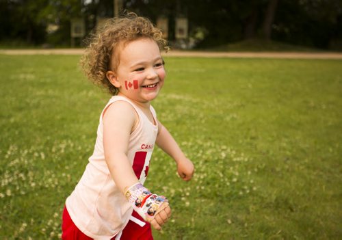 Norah Hall, 2, lets off some steam by running around in the grass on Canada Day at the Forks on Wednesday, July 1, 2015. Mikaela MacKenzie / Winnipeg Free Press