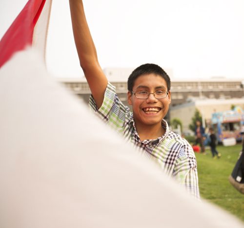 Dante Whiteman waves a Canadian flag on Canada Day at the Forks on Wednesday, July 1, 2015. Mikaela MacKenzie / Winnipeg Free Press