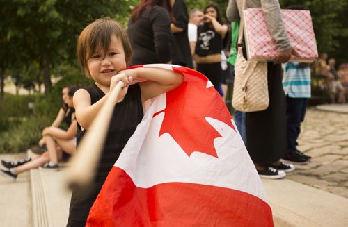Ryder Duck, 4, holds a Canadian flag on Canada Day at the Forks on Wednesday, July 1, 2015. Mikaela MacKenzie / Winnipeg Free Press