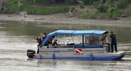 Members of the Winnipeg Police Underwater Search and Recovery Unit are back Thursday morning searching the Red River near the end of Burrows Ave. where an angler caught a clump of dark brown hair that appeared to be from a human. Wayne Glowacki / Winnipeg Free Press July2  2015