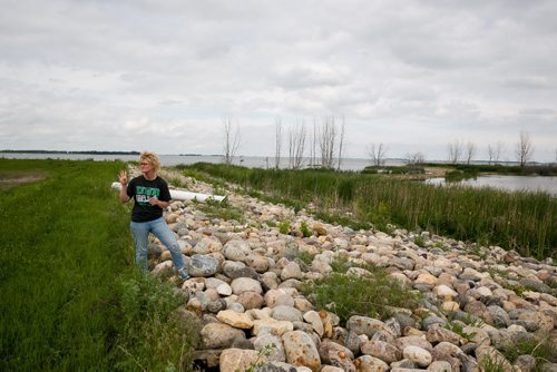 Sherry on the dyke in Minnewaukan built to protect the town from the rising water levels of Devil's Lake. To the right is a former basketball court and football field for the nearby by school.  See story by Mary Agnes Welch June 19, 2015 - MELISSA TAIT / WINNIPEG FREE PRESS