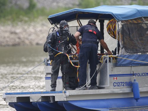 A member of Winnipeg Police Underwater Search and Recovery Unit gets ready to enter the Red River Thursday morning near the end of Burrows Ave.  where an angler caught a clump of dark brown hair that appeared to be from a human.   Kevin Rollason story.Wayne Glowacki / Winnipeg Free Press July 2  2015