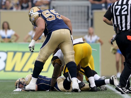 Hamilton Tiger-Cats'  Taylor Reed (44) and Ted Laurent (97) sack Winnipeg Blue Bombers' quarterback Drew Willy (5). Willy would be hurt on the play and be forced to leave the game. Thursday, July 2, 2015. (TREVOR HAGAN/WINNIPEG FREE PRESS)