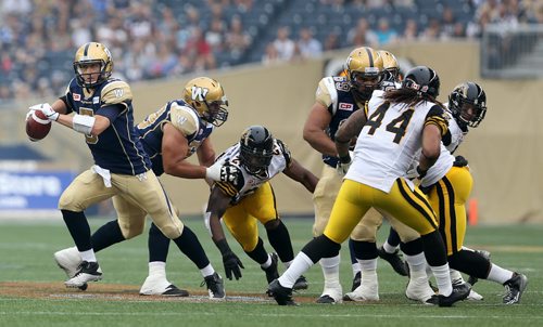 Winnipeg Blue Bombers' quarterback Drew Willy (5) before getting hurt while playing against the Hamilton Tiger-Cats'  during first half CFL action, Thursday, July 2, 2015. (TREVOR HAGAN/WINNIPEG FREE PRESS)