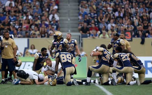 Winnipeg Blue Bombers' quarterback Drew Willy (5) lays on the field after being hurt while playing against the Hamilton Tiger-Cats'  during first half CFL action, Thursday, July 2, 2015. (TREVOR HAGAN/WINNIPEG FREE PRESS)