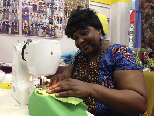 Central Park women's Resource Centre exec director Melrose Koineh uses one of the few working sewing machines at the centre that is getting United Way crowd-funding to buy new ones.  Carol Sanders / Winnipeg Free Press July 2015