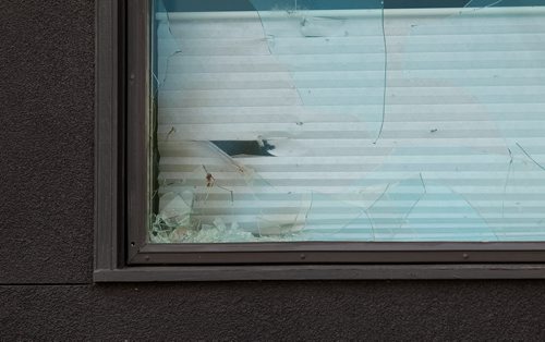 Tight shot of broken window appears to have blood sprayed on it at Petersen and King Law Office at 252 River Ave. where a bomb exploded Friday morning.   See story.  July 03,, 2015 Ruth Bonneville / Winnipeg Free Press